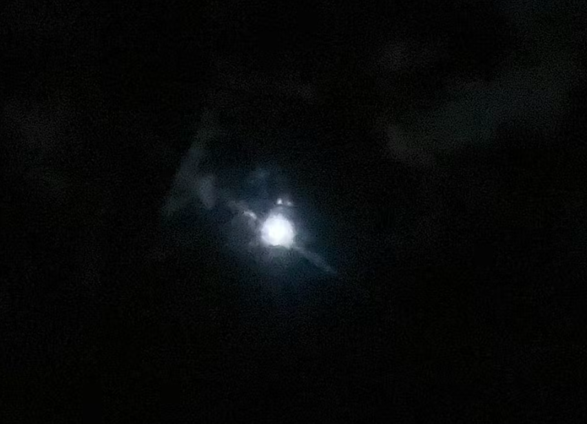Blurry photo of the moon on a dark background
