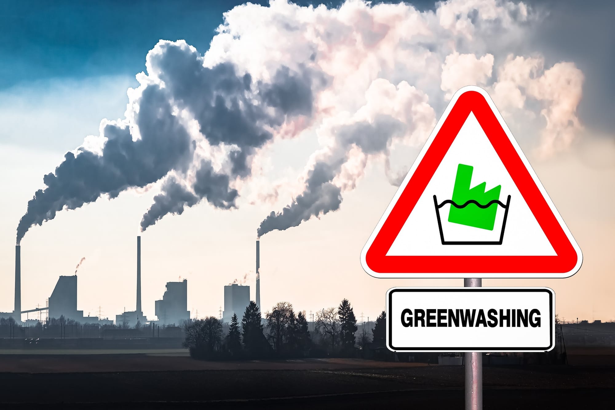 Warning against greenwashing on a sign, against an industrial background.