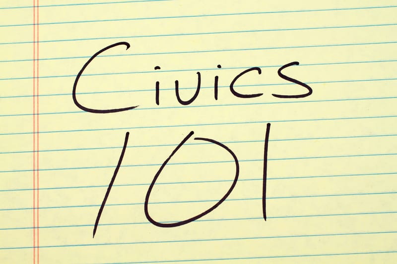 The words "Civics 101" on a yellow legal pad.