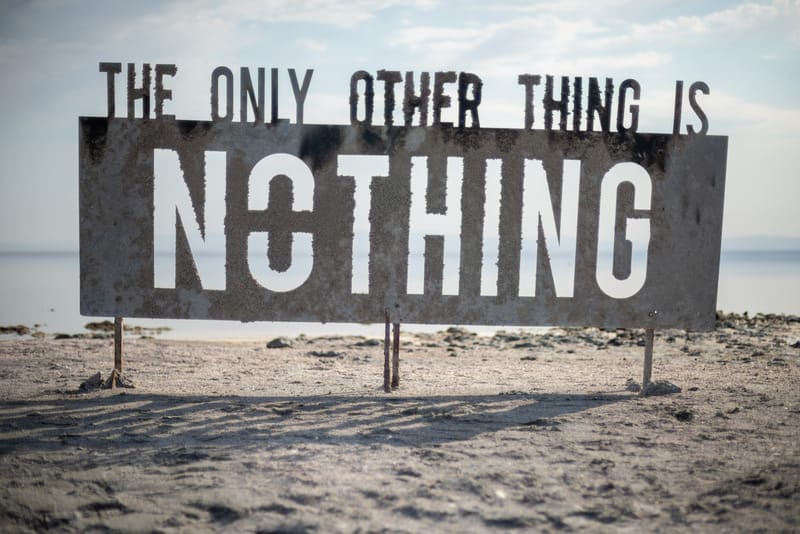 A sign on a beach reading "The only other thing is nothing"