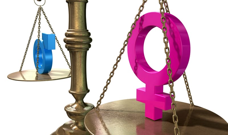 A gold justice scale with the two different gender symbols on either side balancing each other out on an isolated white background